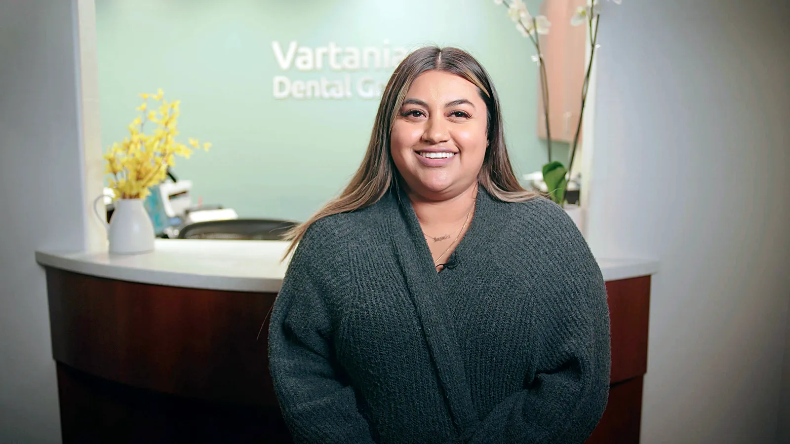 Thumbnail of a woman smiling at the dentist office.