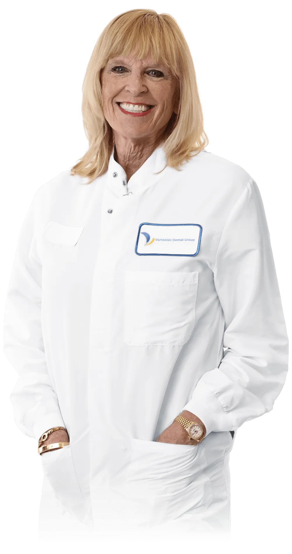 Female dentist in scrubs posing with hands in pockets.