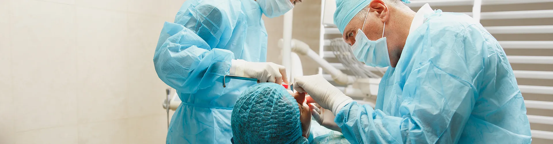 dentists using dental tools in patient's mouth