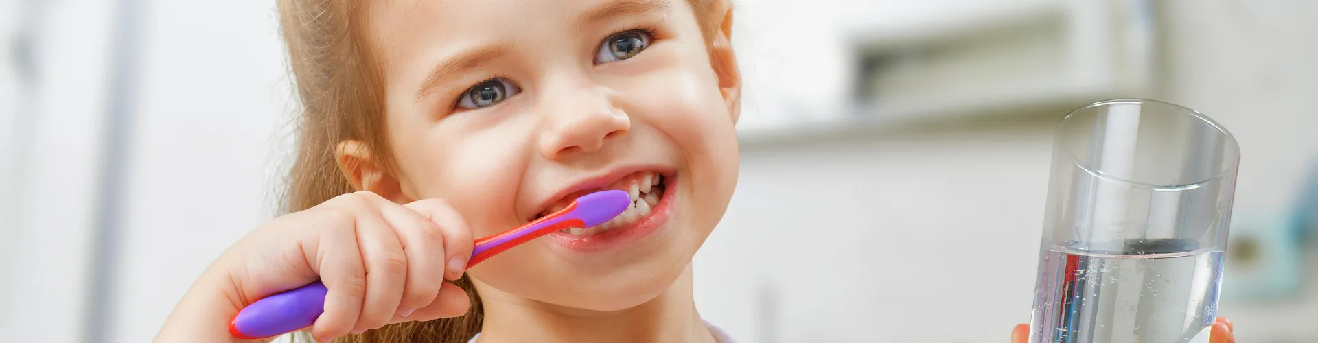Young girl brushing her teeth.