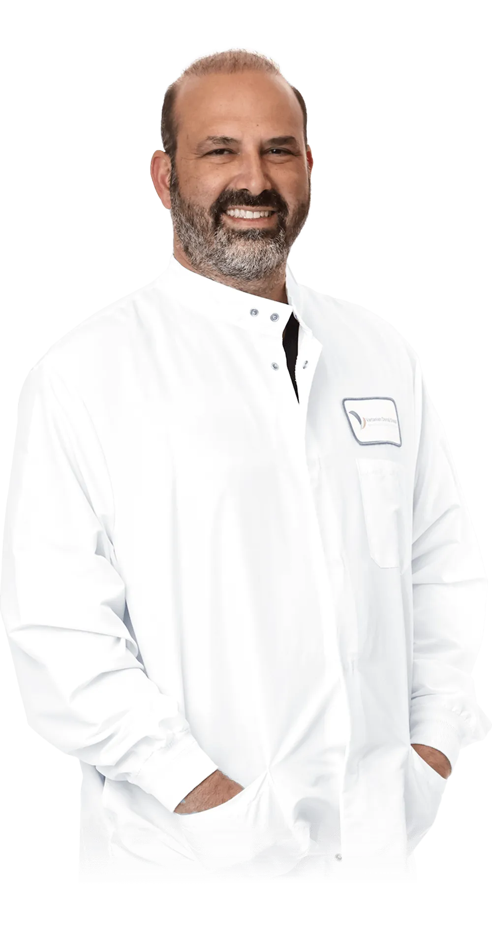 Portrait of Dr. James Vartanian in a white dentist coat, smiling, with his name badge displayed.